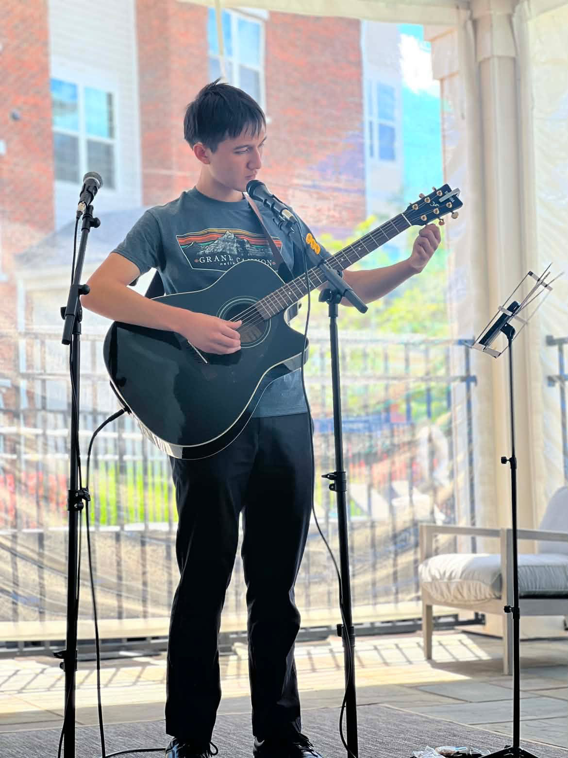 0F18A3E2-A6A9-4C99-8642-052F7C5F4CC4 (1) Image of Ethan Garcia playing a guitar.